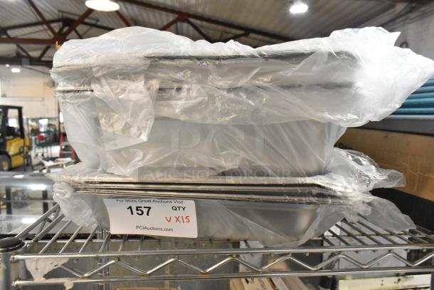 Brand new scratch and dent items include Choice aluminum bun pan and stainless steel bins, wrapped in plastic, on a metal shelf.