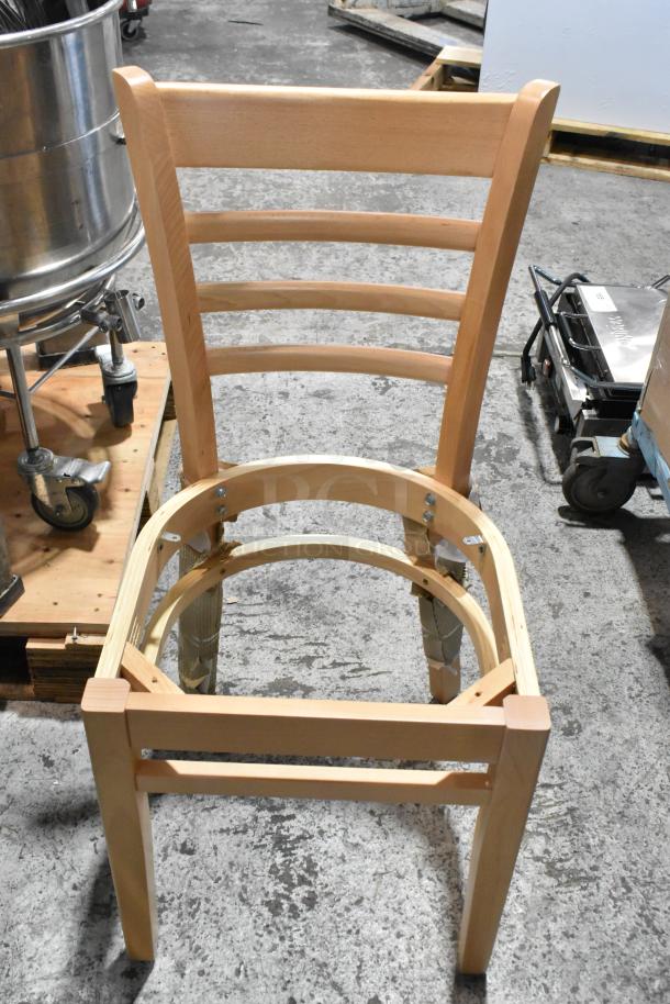 Brand new wooden dining chair with ladder back design. Shows minor scratch and dent. Auction includes three items.