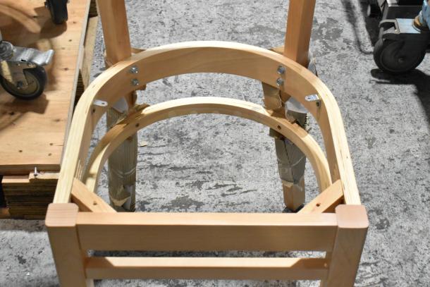 Three brand new wooden dining height chairs, scratch and dent condition, with ladder back design and assembled frames.