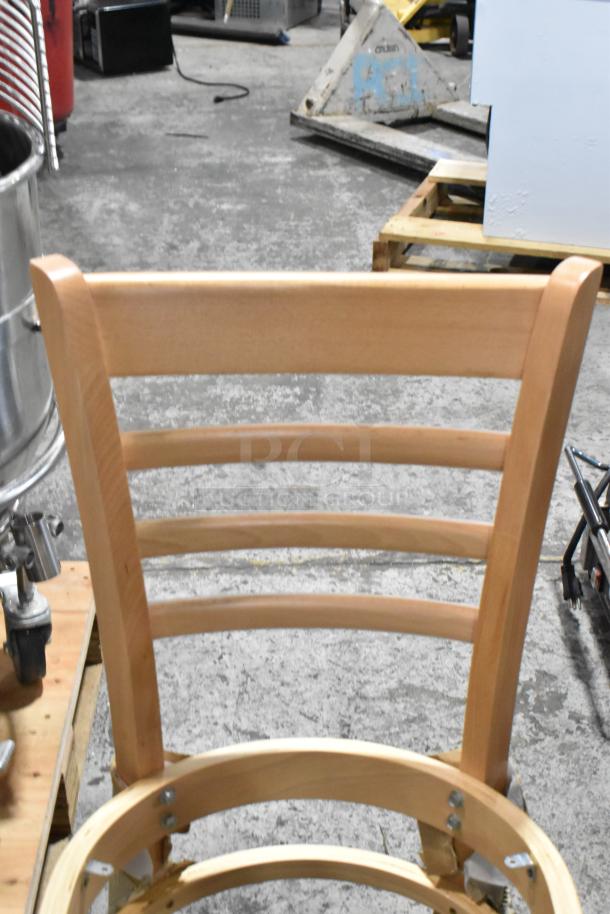 Three brand new wooden ladder back dining chairs, model 164CLADNATFR, in flawless condition.