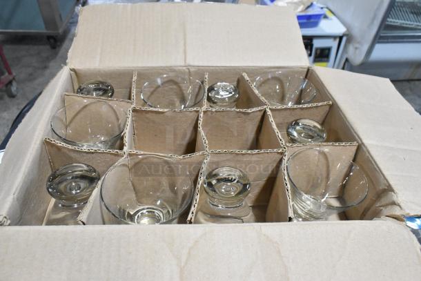 Box of new glassware, including Anchor Hocking rocks glasses and Acopa wine glasses. Scratch and dent condition.