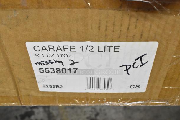 Label on a cardboard box for 17 oz. glass carafes, noting "missing 2," item code 5538017, and PCI markings.