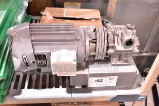 Brand new scratch and dent capacitance asynchronous motor, 110 volts, 1 phase, visible minor dents, ID tag labeled "162."