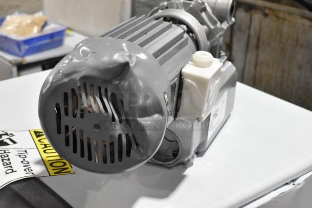 Brand new capacitance asynchronous motor, 110 volts, 1 phase, with visible dents on the casing. Caution label present.