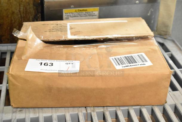 Brown cardboard box with visible barcode and auction label marked "163." Box shows minor dents, labeled for a spray nozzle attachment.