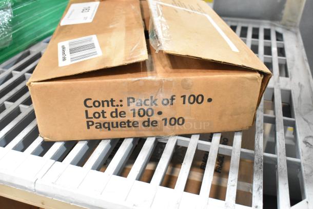 Cardboard box labeled "Pack of 100" with light scratches and dents, containing brand new spray nozzle attachments.