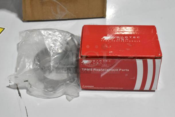 Box of TPMS Replacement Parts by Bartec USA, sealed in plastic, labeled with warning about cancer and reproductive harm.