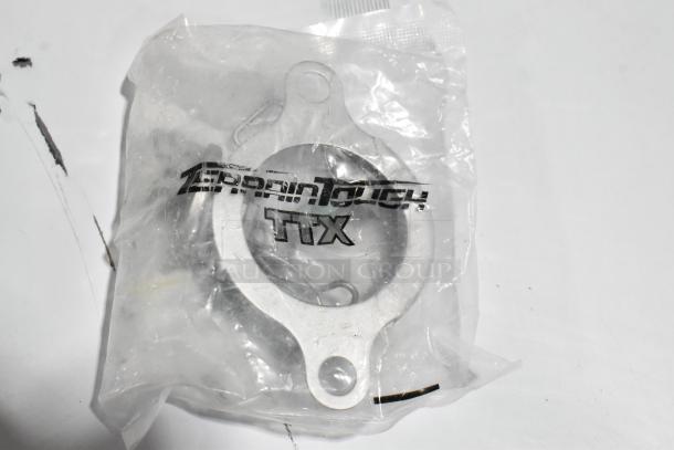 Plastic-wrapped metal component labeled "TIX," part of new Cooking Performance Group auction set.