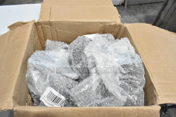 Cardboard box containing bubble-wrapped, brand new Cooking Performance Group 351CASTER4 casters, CYS-010 Electric Faucet, parts box.