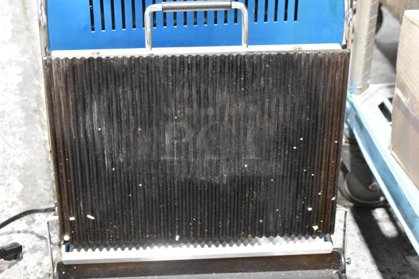 Waring WDG250 Stainless Steel Panini Press, 120V, commercial, ribbed plates, showing signs of use.