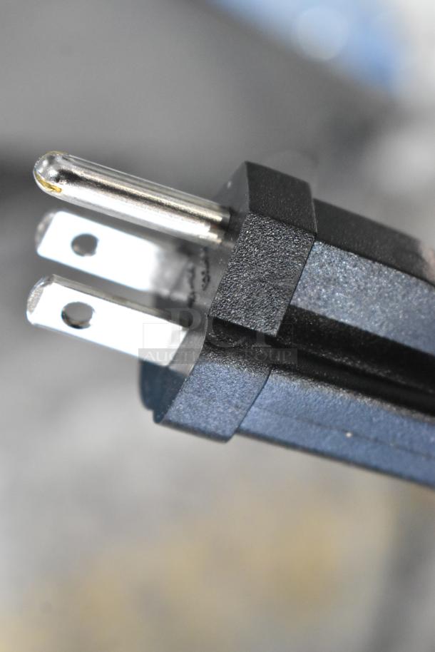 Close-up of a standard three-prong plug for Waring WDG250 Panini Press, 120 volts, indicating compatibility with common outlets.