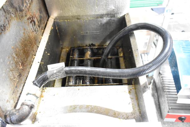 Dean SR42GNS stainless steel gas deep fryer on casters, 105,000 BTU. Interior shows signs of use with grease buildup.