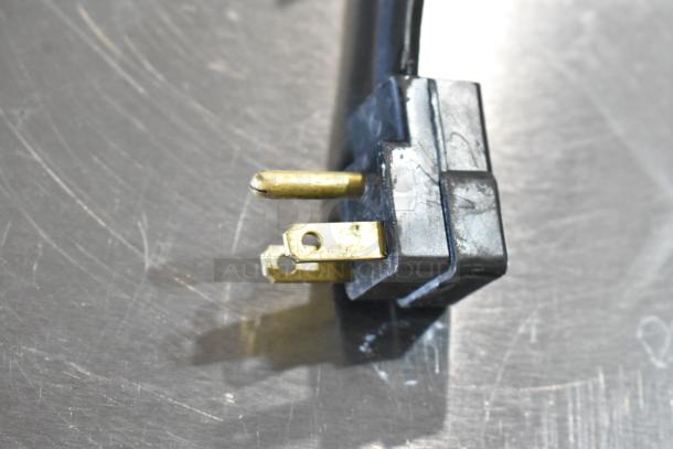 Close-up of a plug from a Beverage Air UCFD36AHC-2 stainless steel undercounter freezer, 115 volts, 1 phase.