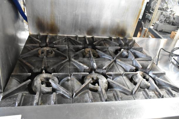Garland X36-6R SunFire stainless steel 6 burner range with oven, over shelf, and back splash. Commercial gas, good condition.