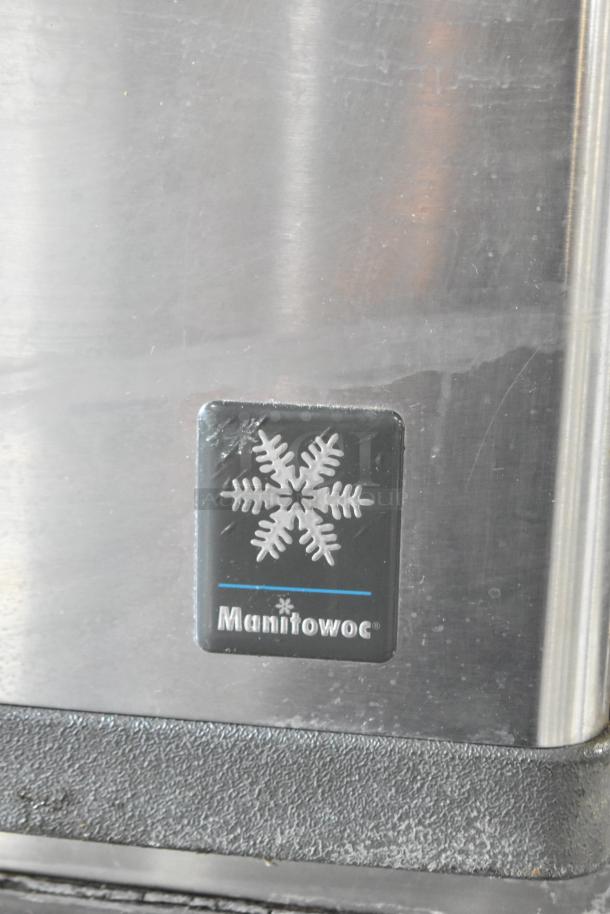 Manitowoc QD0452A stainless steel ice machine head on ice bin, 115V, 1 phase, commercial use, logo visible, good condition.