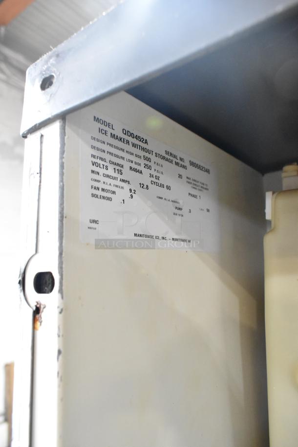 Manitowoc QD0452A ice machine head, stainless steel, on commercial bin. Shows model label, 115V, 1 phase.