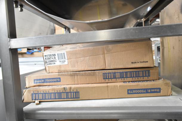Stainless steel commercial meat slicer stand by M&E Manufacturing, featuring metal bowls; includes labeled boxes.
