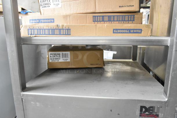 M&E Manufacturing stainless steel commercial meat slicer equipment stand, features contents including metal bowls, sturdy condition.