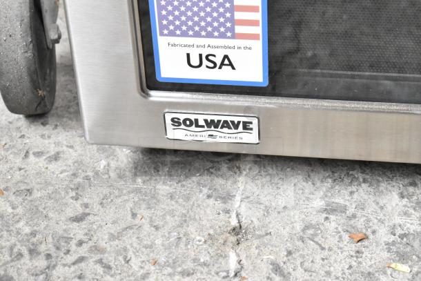 Brand new Solwave SWAHD18 stainless steel commercial microwave, scratch and dent, with US assembly label visible.