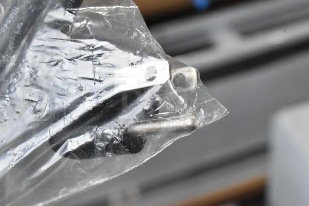 Plastic-wrapped hardware for the Carnival King 382HDSG2A hot food display case, showing metal components.