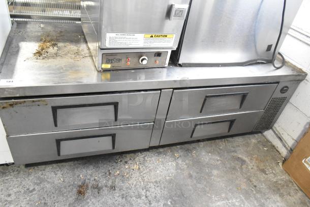 True stainless steel commercial chef base with 4 drawers on casters. Features 115 volts, 1 phase power. Visible wear.
