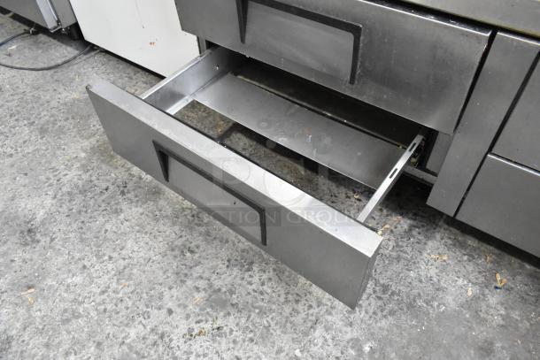 True stainless steel 4-drawer chef base on commercial casters, 115V, 1 phase, used condition, visible handle and interior.