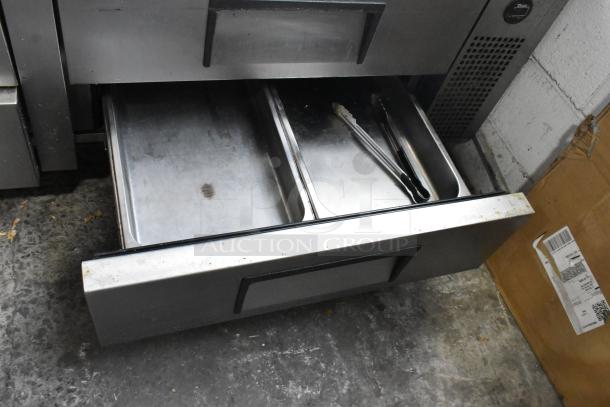 True Stainless Steel 4-Drawer Chef Base on casters, 115V, 1 phase, in used condition, visible wear and utensils inside.