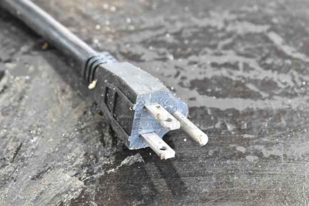 Close-up image of a power plug for the Carnival King 382TCMPT16A crepe maker, showing wear on the prongs.
