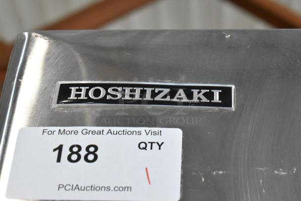 Hoshizaki stainless steel commercial ice machine with label and auction tag. Model supports 125/250V, 3 phase.