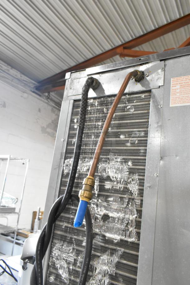 Hoshizaki stainless steel commercial ice machine with visible hoses and connections, 125/250 volts, 3 phase configuration.