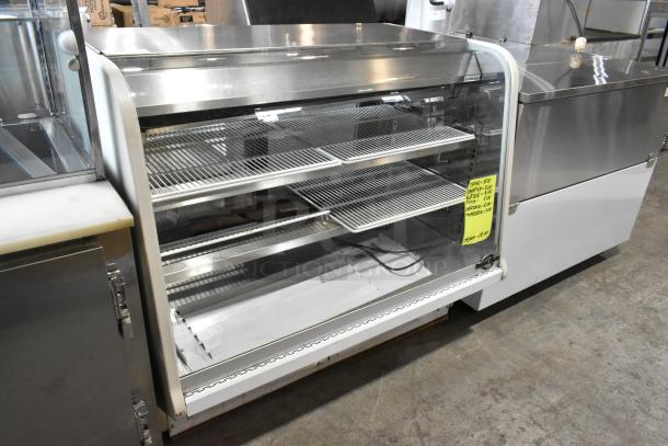 Universal Coolers metal deli display case, floor style. Features glass front, metal shelves, and a label with unit type and pricing.
