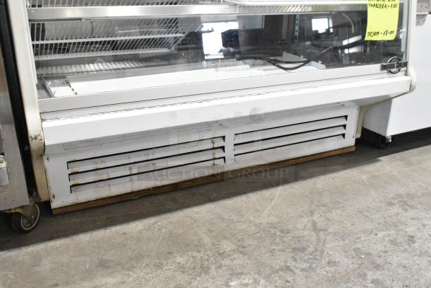 Universal Coolers metal deli display case, commercial floor style, minor rust, glass front, ideal for merchandising.