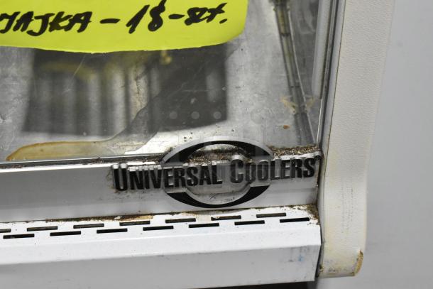 Universal Coolers deli display case with metal frame, visible wear and residue, featuring brand logo. Ideal for commercial use.
