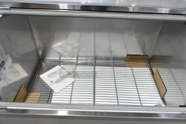 Brand new Avantco 178MC49HC stainless steel milk cooler with commercial casters, scratch, and dent, 49", 115V, 1 Phase.