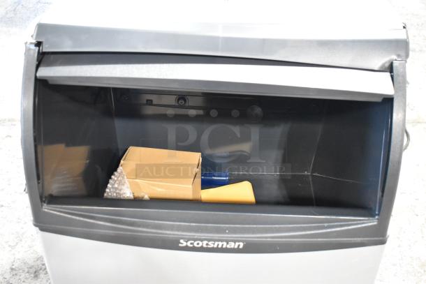 Brand new Scotsman UC2024MA-1A undercounter ice machine, stainless steel, 227 lb capacity, interior shown.