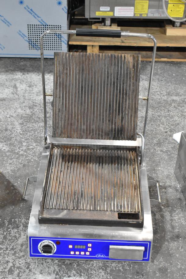 Brand new Globe GPG14D sandwich grill with grooved plates, 14"x14" surface, 120V, 1 phase, scratch and dent condition.