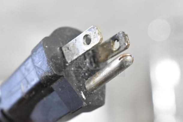 Close-up of a power plug, likely belonging to the Globe GPG14D sandwich grill. Plug shows signs of wear.