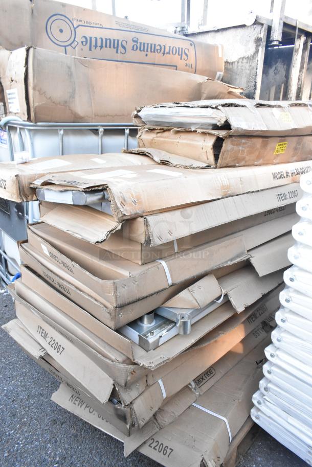 Stack of boxes labeled GR36-DO1272 and Mix Rite 22067. Items appear new but with packaging damage. Various components visible.