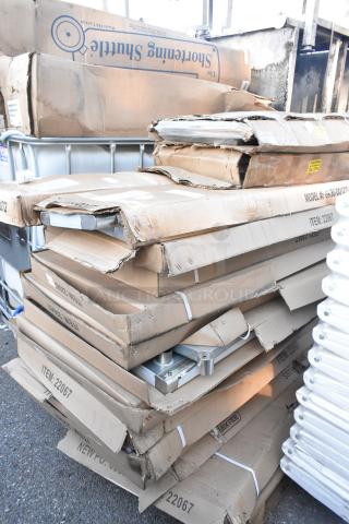 Stack of boxes labeled GR36-DO1272 and Mix Rite 22067. Items appear new but with packaging damage. Various components visible.