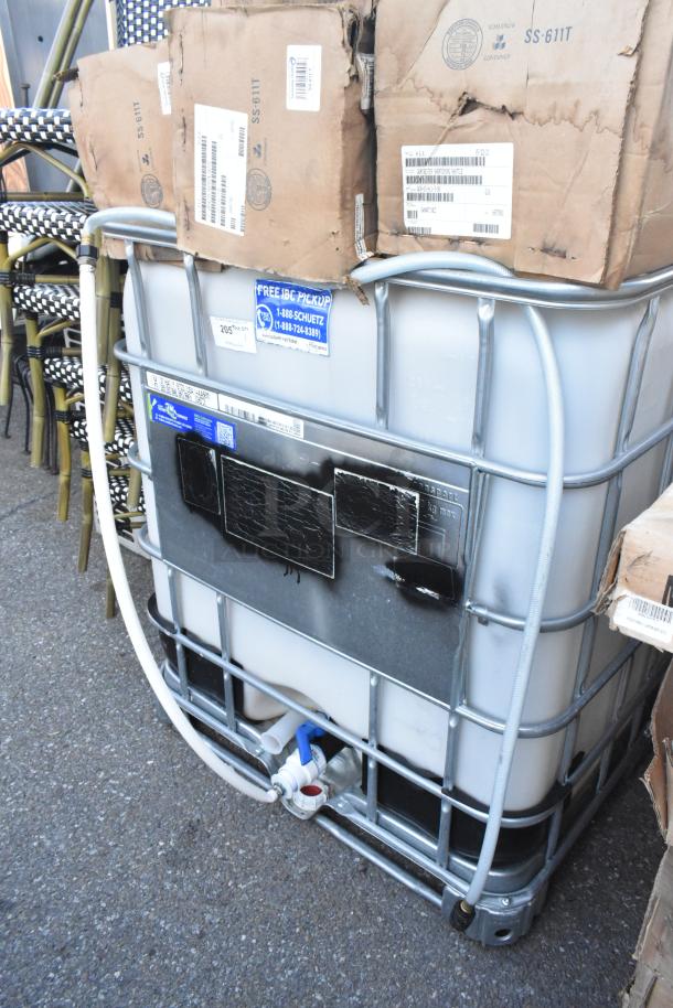 4004909 Ecobulk MX275 Tank, durable plastic with metal cage, visible intake valve and label, used condition.