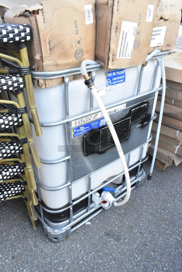 4004909 Ecobulk MX275 Tank, metal cage, spout, visible labels for pickup service, suitable for industrial use.