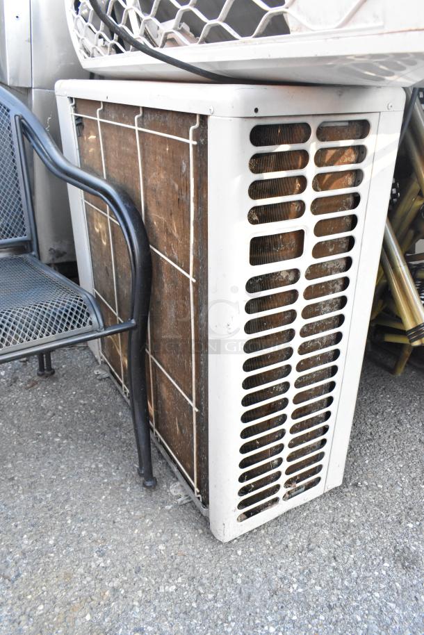Outdoor unit of Friedrich MR36Y3J 33,000 BTU AC/Heat Pump, R-410A, wall-mounted, shows signs of wear.