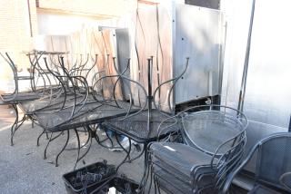 19-piece black metal mesh patio furniture set, including tables and chairs. Stacked and organized for auction.