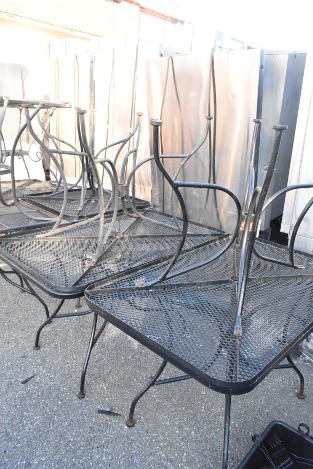 19 black metal mesh patio tables and chairs, stacked. Metal mesh surface, sturdy frames. Used condition.