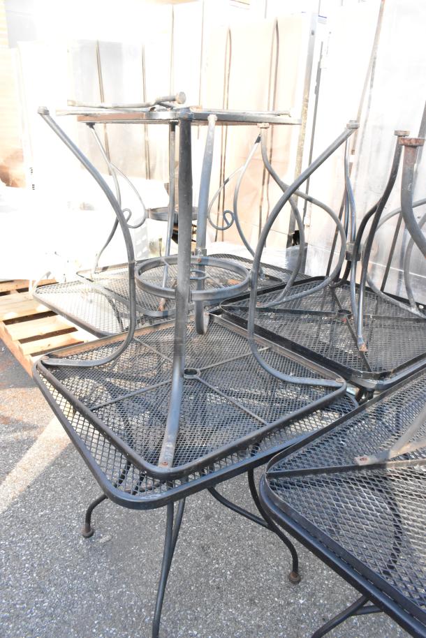Black metal mesh patio furniture set including tables and chairs, used condition, stackable design, visible wear.