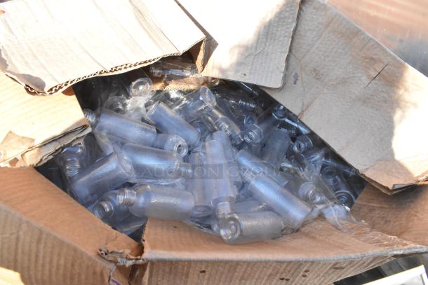 Box containing clear plastic bottles, opened with visible bottle tops. Bottles appear unused, packed tightly in the box.