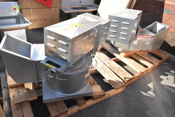 2 new CaptiveAire CASRE13BD metal commercial ventilators on pallets, featuring robust design and visible brand labeling.