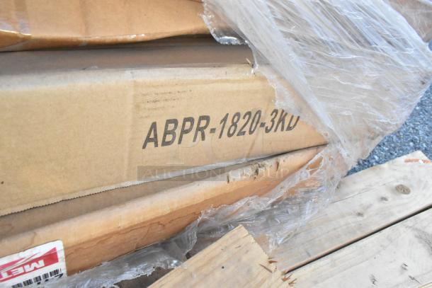 Boxes of new items including John Boos ABPR-1820-3KD Bun Pan Rack. Packaging intact, items bundled on a pallet.