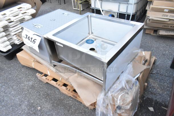 Brand new Regency stainless steel floor mop sink, 24" x 24" x 12" bowl, displayed on a pallet. Label: 1416.