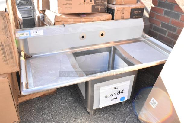 BRAND NEW Regency 600S11818218 stainless steel single bay sink with dual drain boards, scratch and dent condition. No legs.